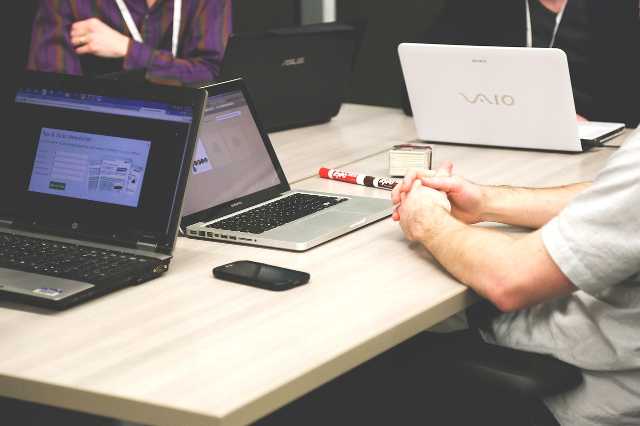 Laptops, meeting, businessmen — Enhancing Costa Rican Lives through English Education