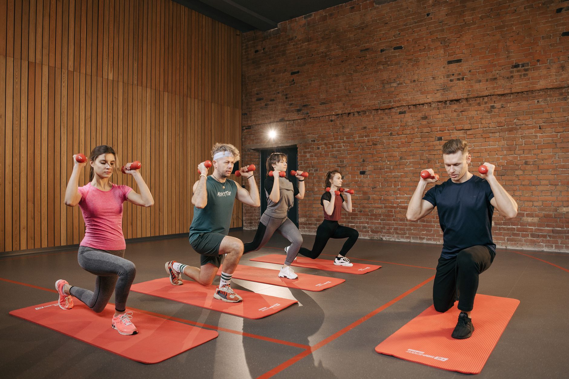 Indoor group workout session with dumbbells focusing on strength and fitness. — The Benefits of HGH in Maintaining Youthful V