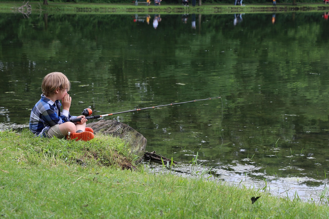 Child fishing, child by pond, fishing — Top Benefits of Entering Carp Fishing Raffles