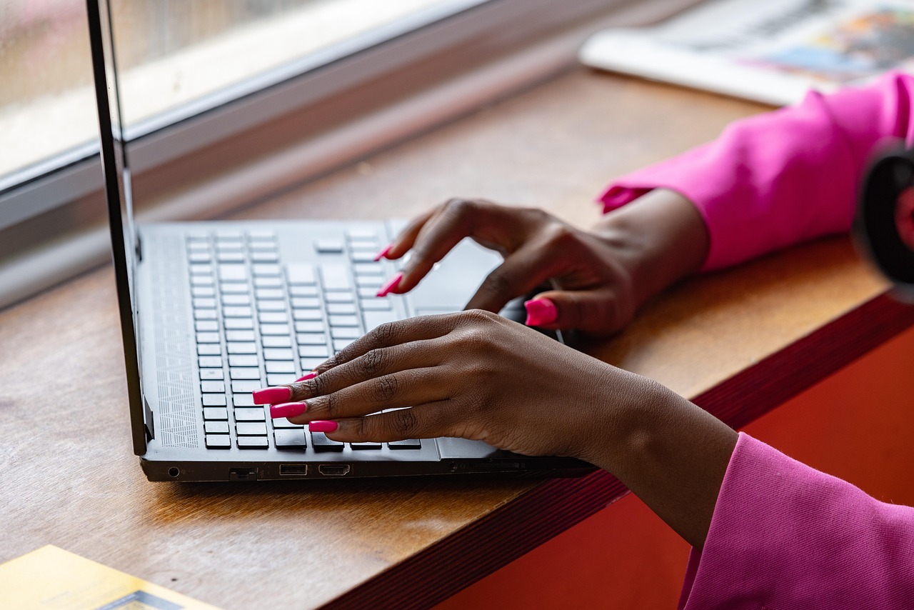 Laptop, typing, working — Unlocking Consciousness: The Importance of Psilocybin Spores in Mental Health Research