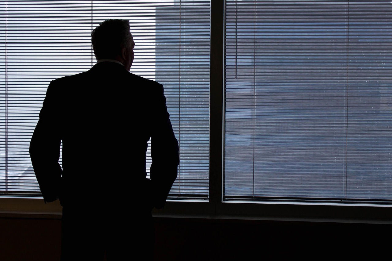 Businessman, silhouette, windows — Why Use An Umbrella Company Calculator
